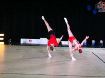 A men and a women performing aerobics gymnastics element